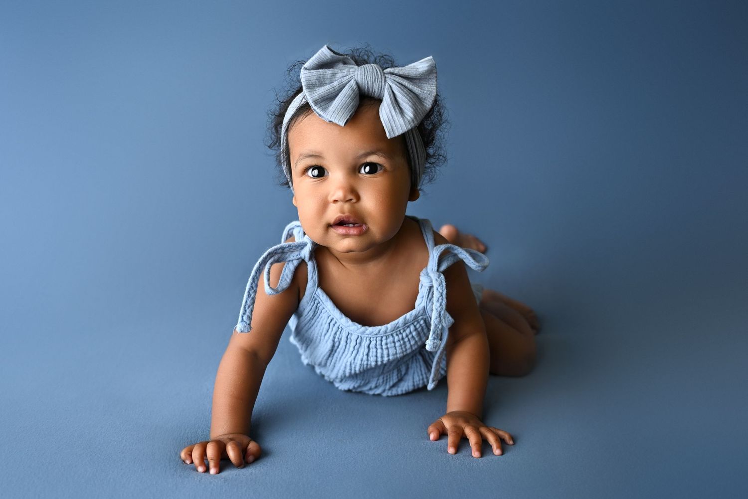 Blue background in luxury headshot milestone sitter session in Phoenix Arizona