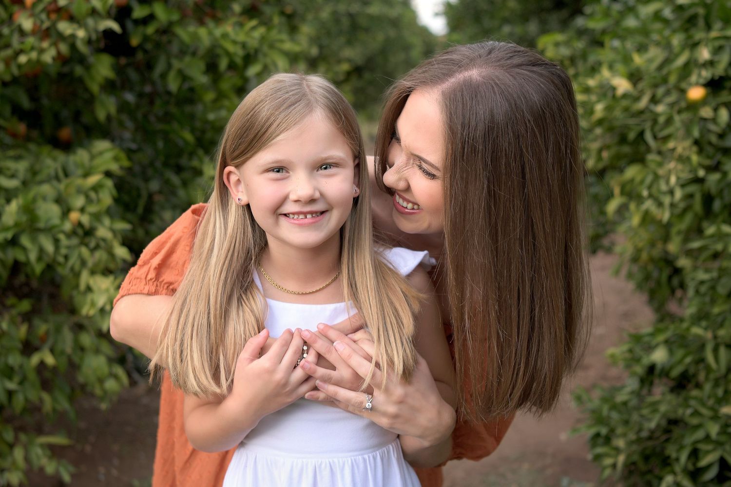 Mom stares at her young daughter lovingly in Rustic arizona Gilbert farm