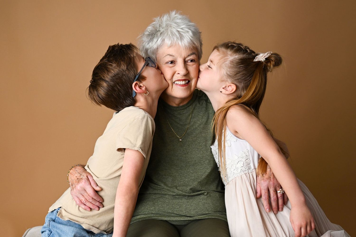 Two children kiss their Great Grandmother on the cheek in Arizona