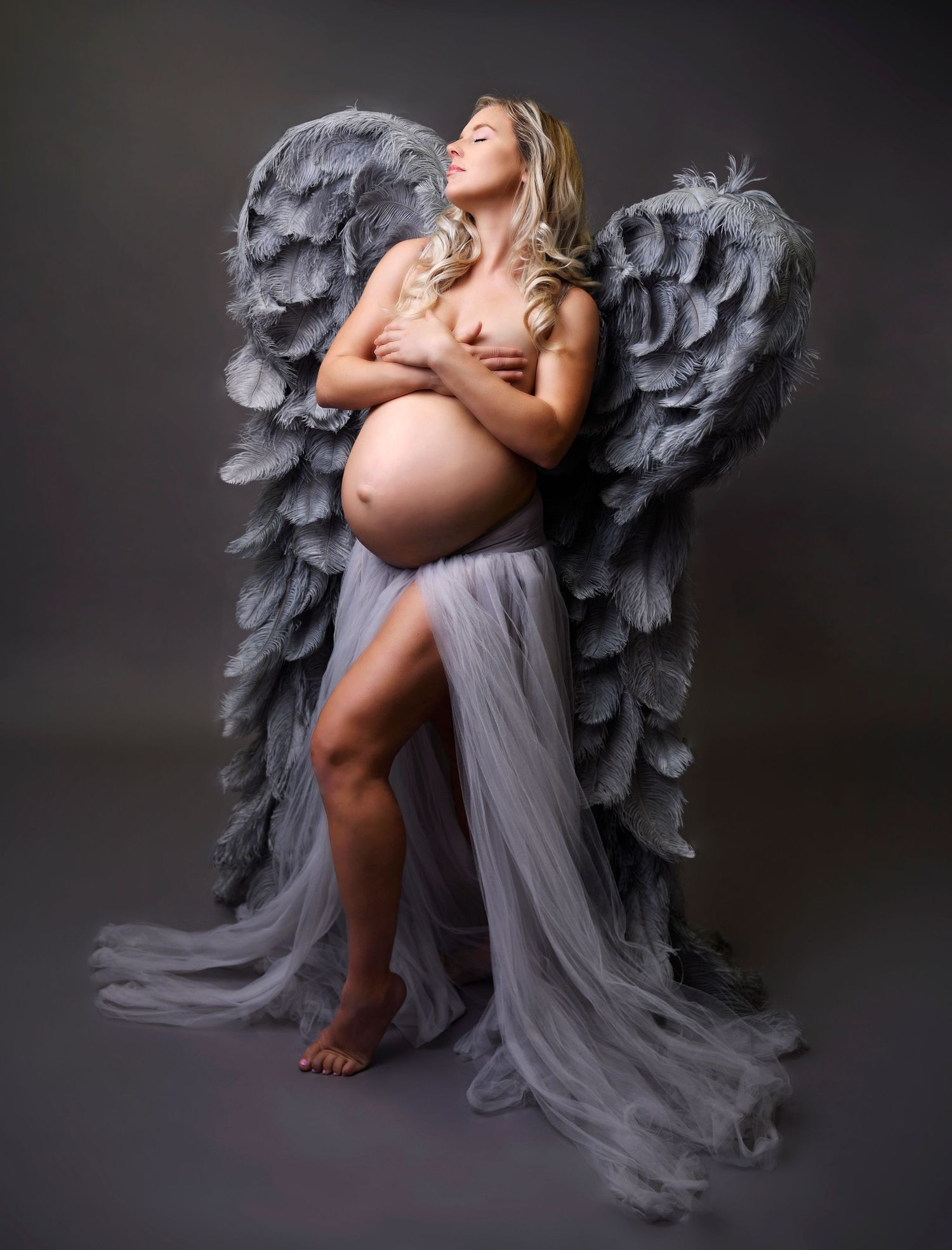 Luxury fine art maternity photo of woman posing in angel wings topless. Scottsdale Arizona Maternity photographer
