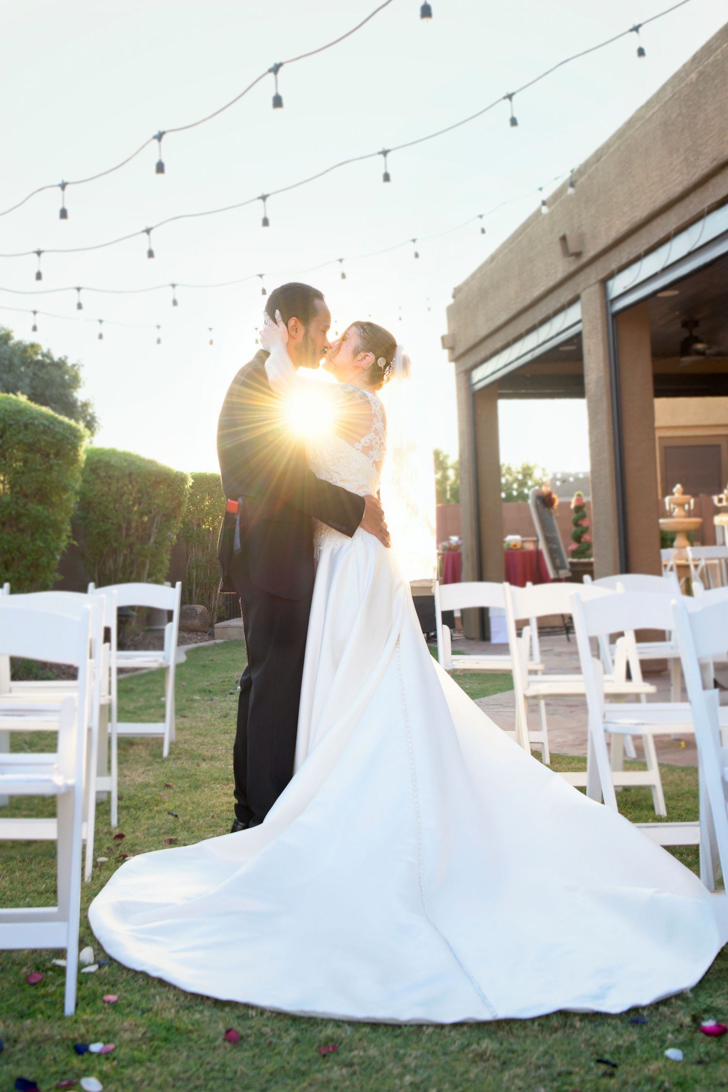 Wedding photo of couple kissing with gorgeous sunset light glowing through them