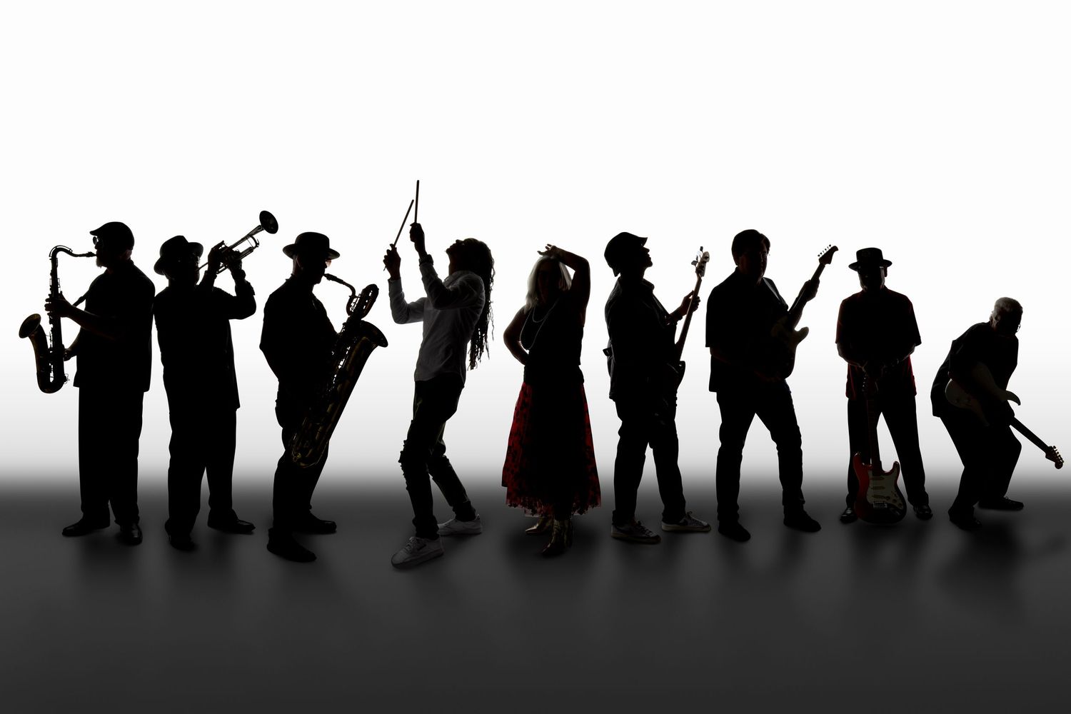 Backlit silhouette image of Cold Shott band holding their instruments and jamming out in Arizona.