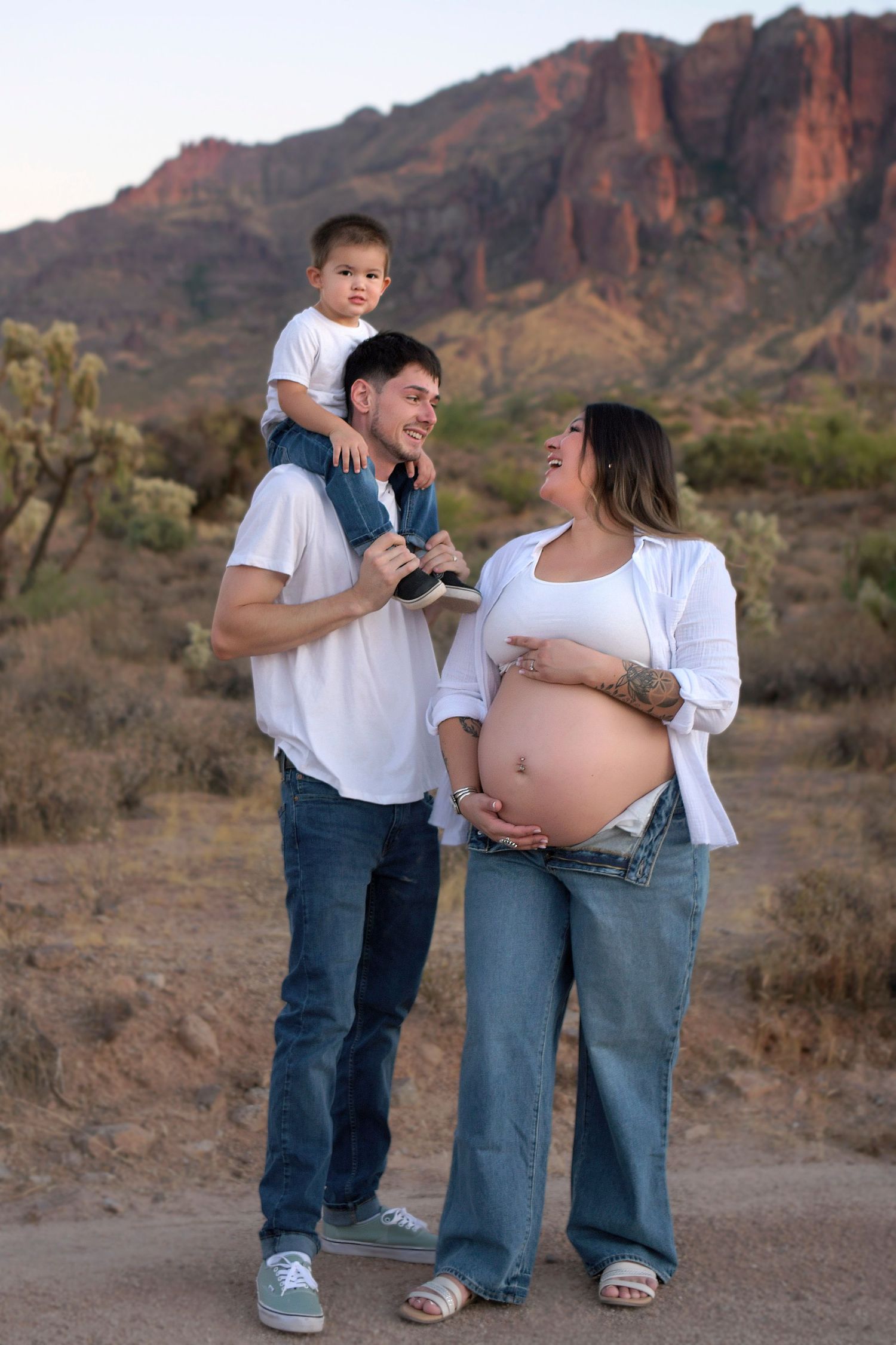 Pregnant Mom with her husband and toddler surrounded by the Arizona desert in the Superstition Mountains.