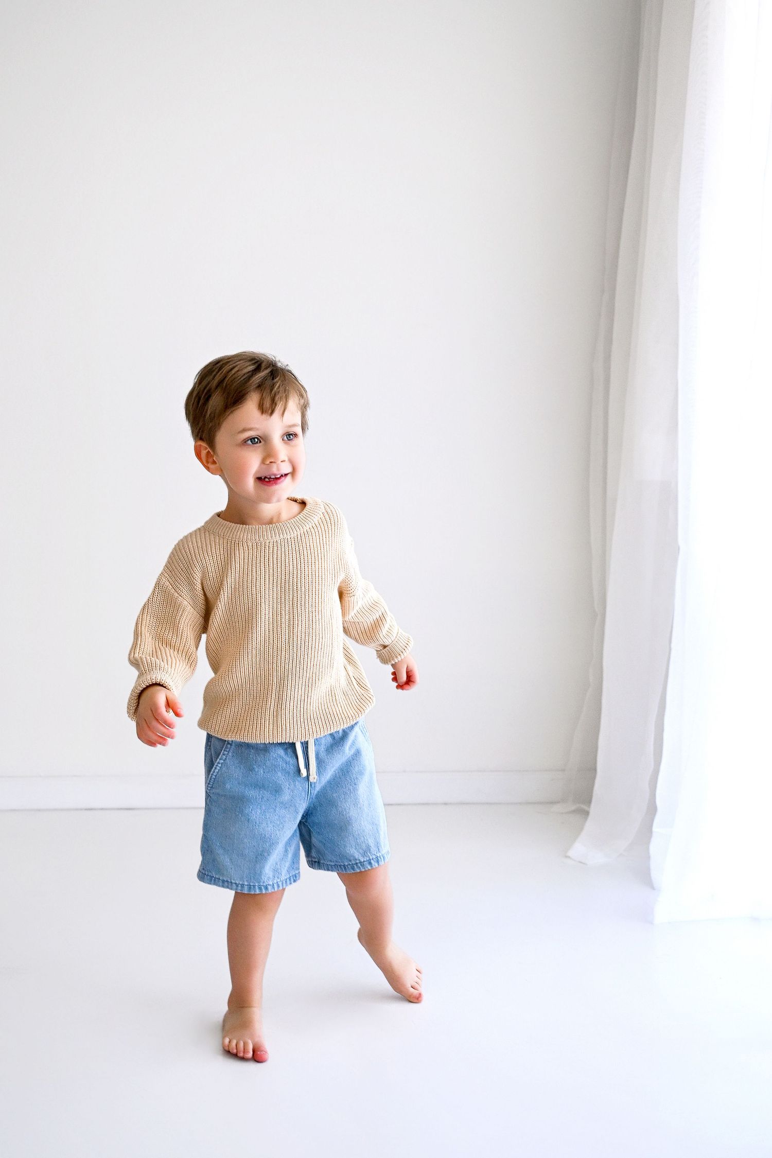 Birthday Mini session natural light all white studio image of little boy in Arizona