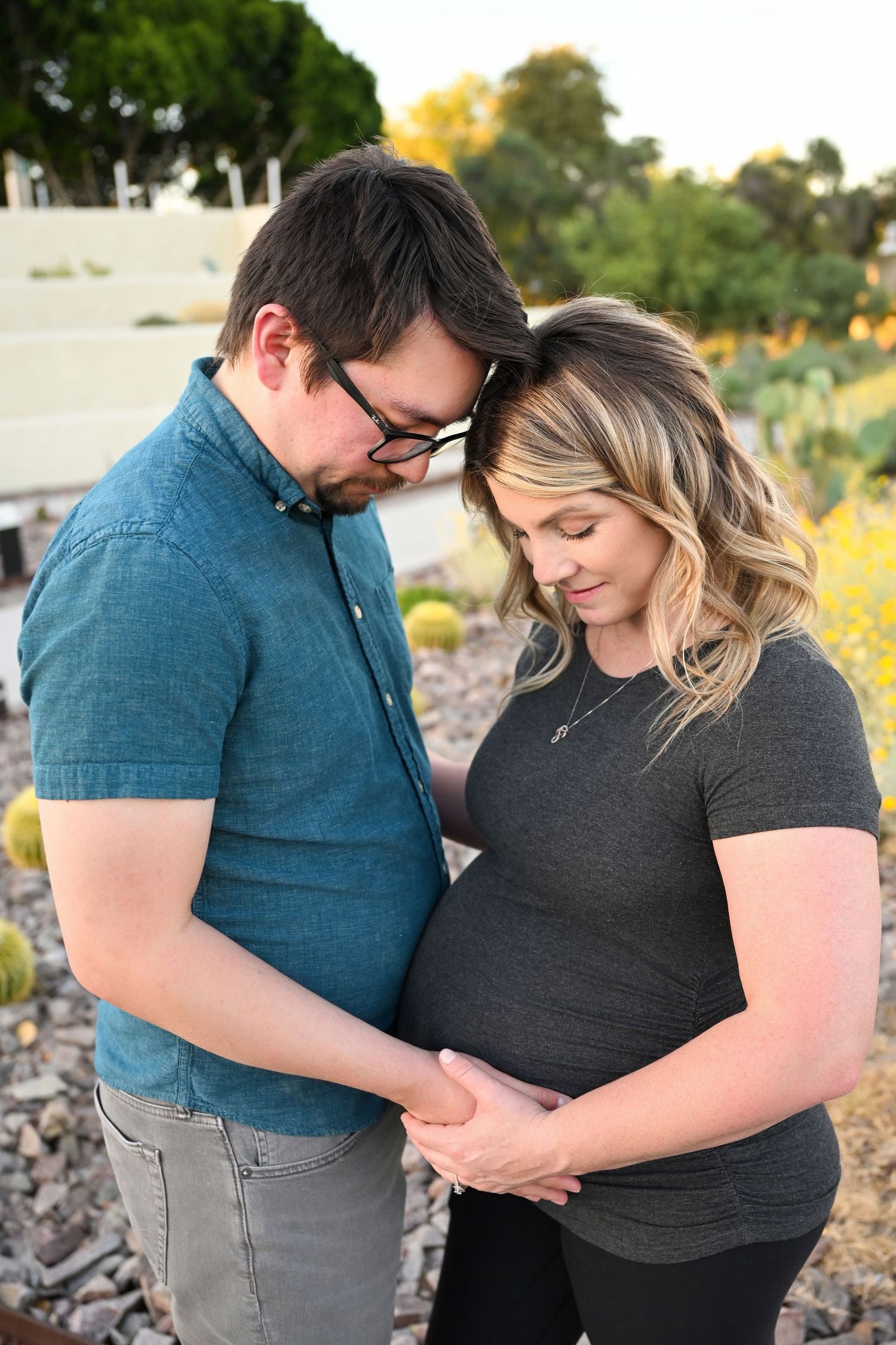 Expectant mother with a glowing smile in a downtown park.