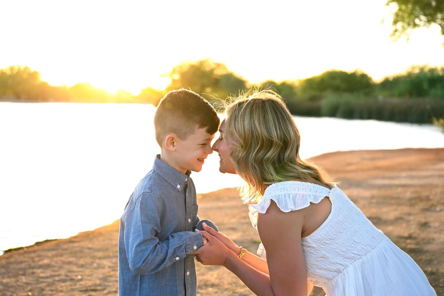 Mother and Son have a loving candid natural moment on the rivers edge with sunset behind them Arizona Golden Hour
