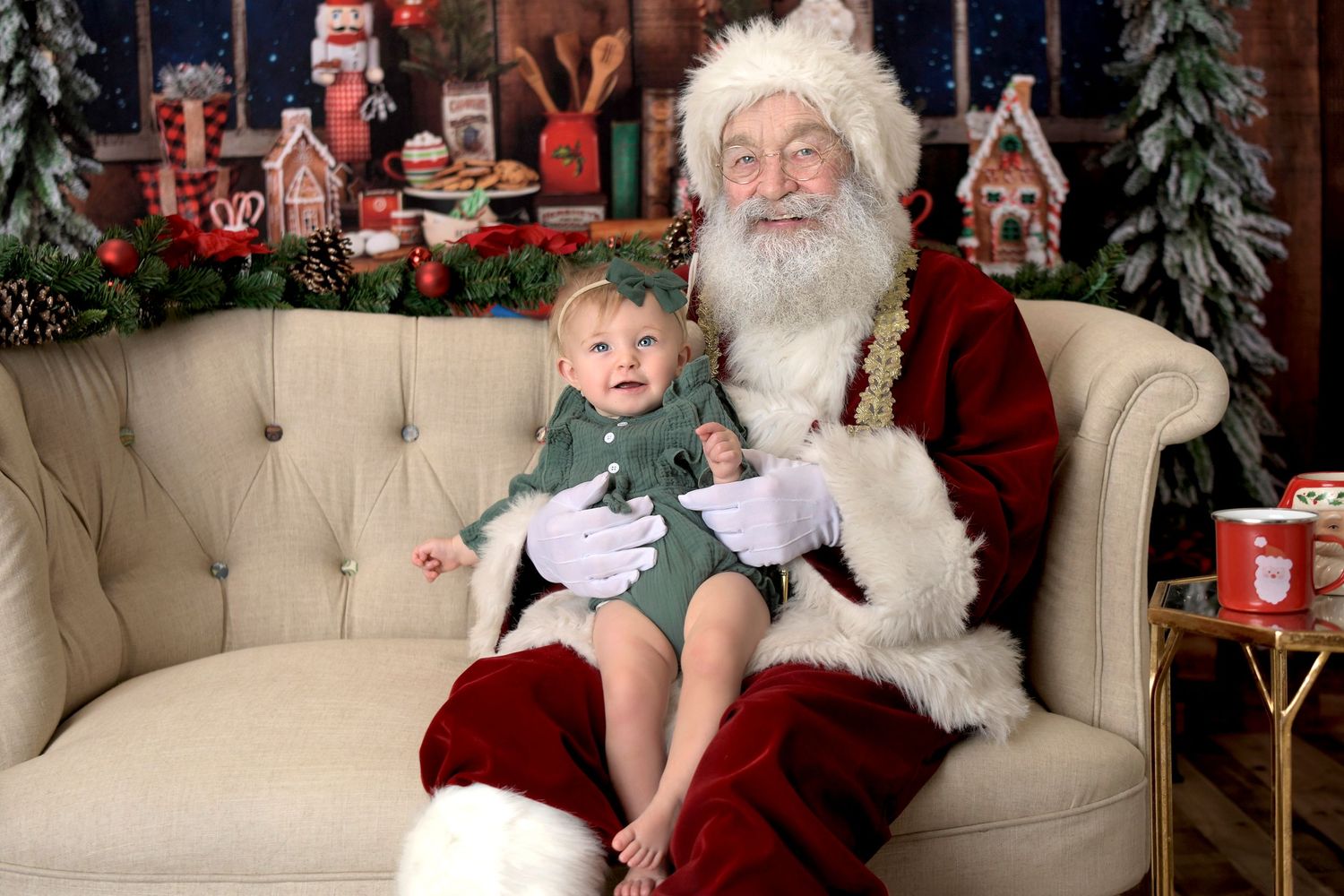 Santa Claus Holiday Christmas Mini Session in Santa's workshop with baby girl sitting on his lap