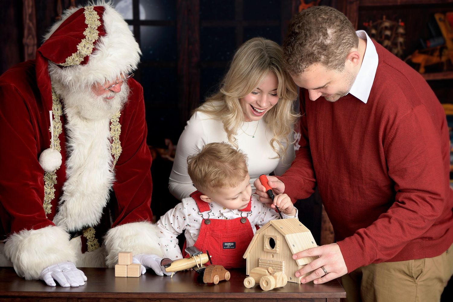 Family and Santa Claus build toys in North Pole Santas workshop AZ