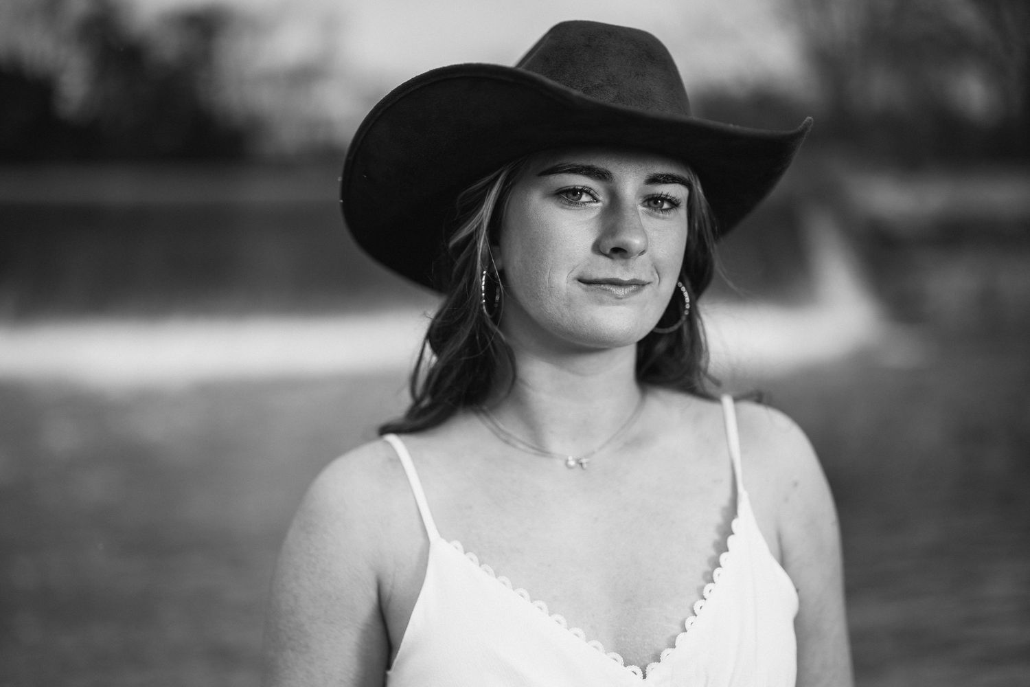 Black and white portrait wearing cowboy hat and white top with delicate necklace. Nashville, Tennessee.