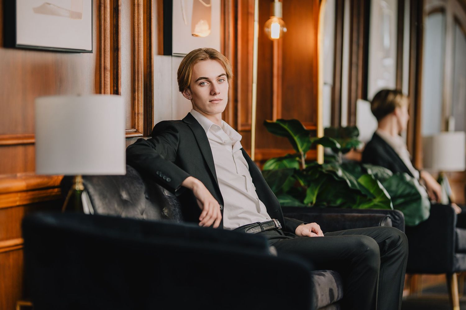 Business casual portrait in modern office lounge with warm lighting and leather seating. Nashville, Tennessee.
