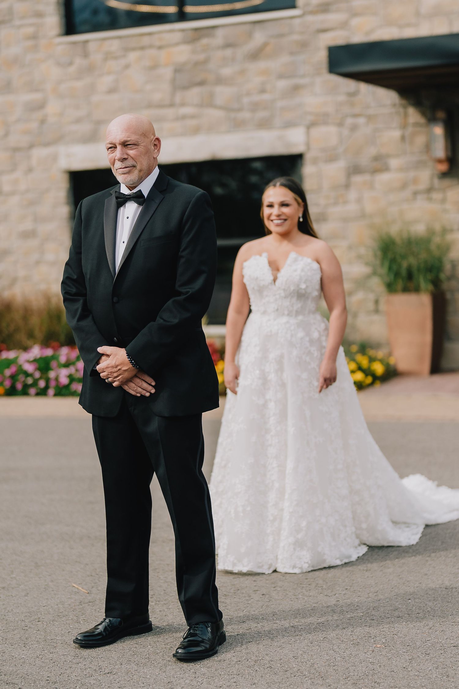 A first look wedding moment captured outside a stone building with flowers. Nashville, Tennessee