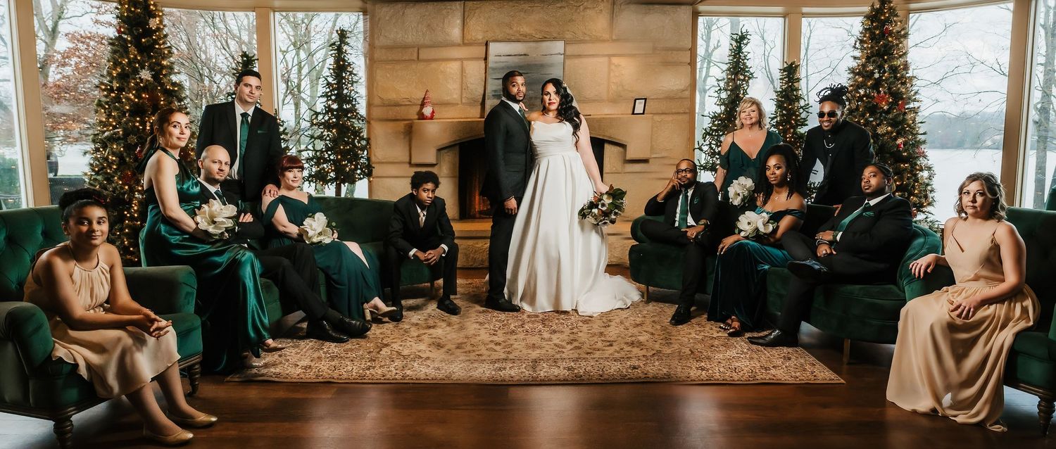 Wedding party gathered in rustic wood-paneled room with Christmas trees. Nashville, Tennessee.