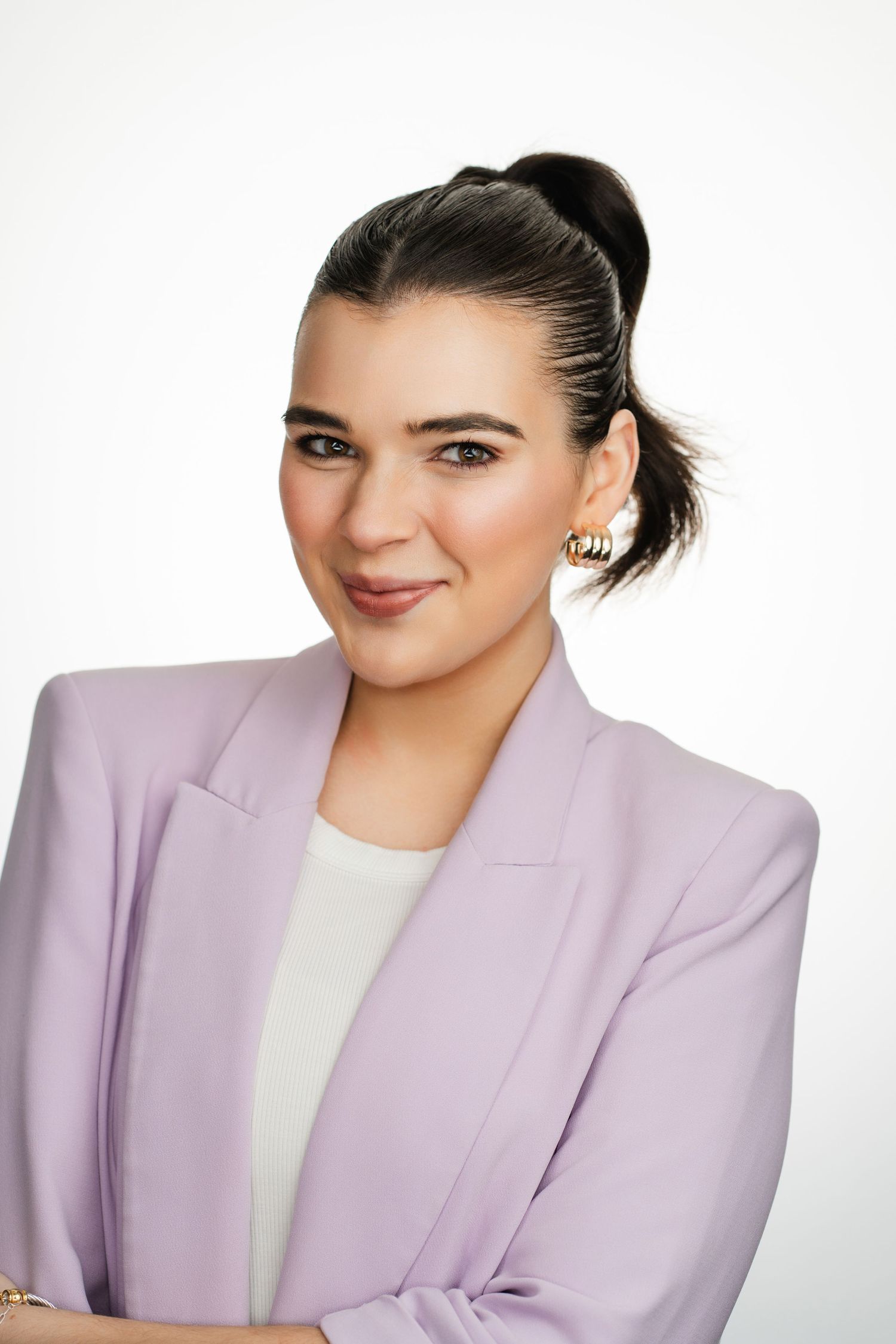 Professional portrait of woman in lavender blazer against white background. Nashville, Tennessee.