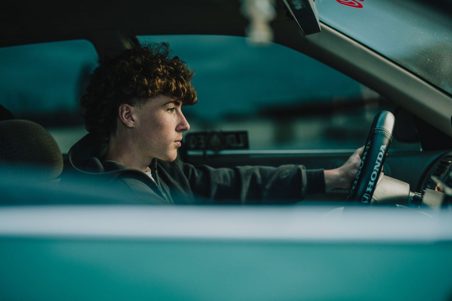A profile view of someone driving a car in moody lighting. Murfreesboro, Tennessee.