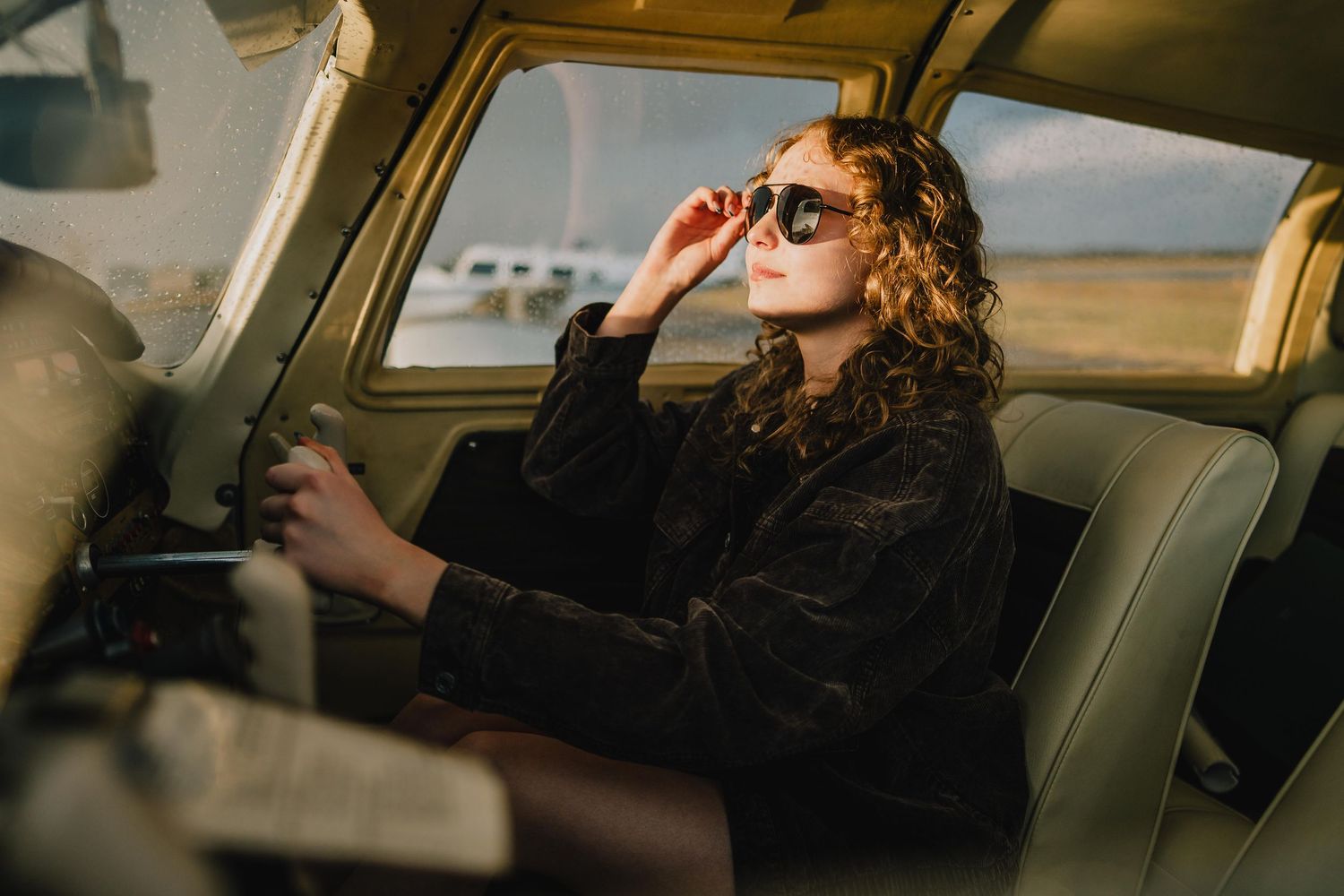 Vintage-style portrait of someone wearing sunglasses in classic car interior. Murfreesboro, Tennessee