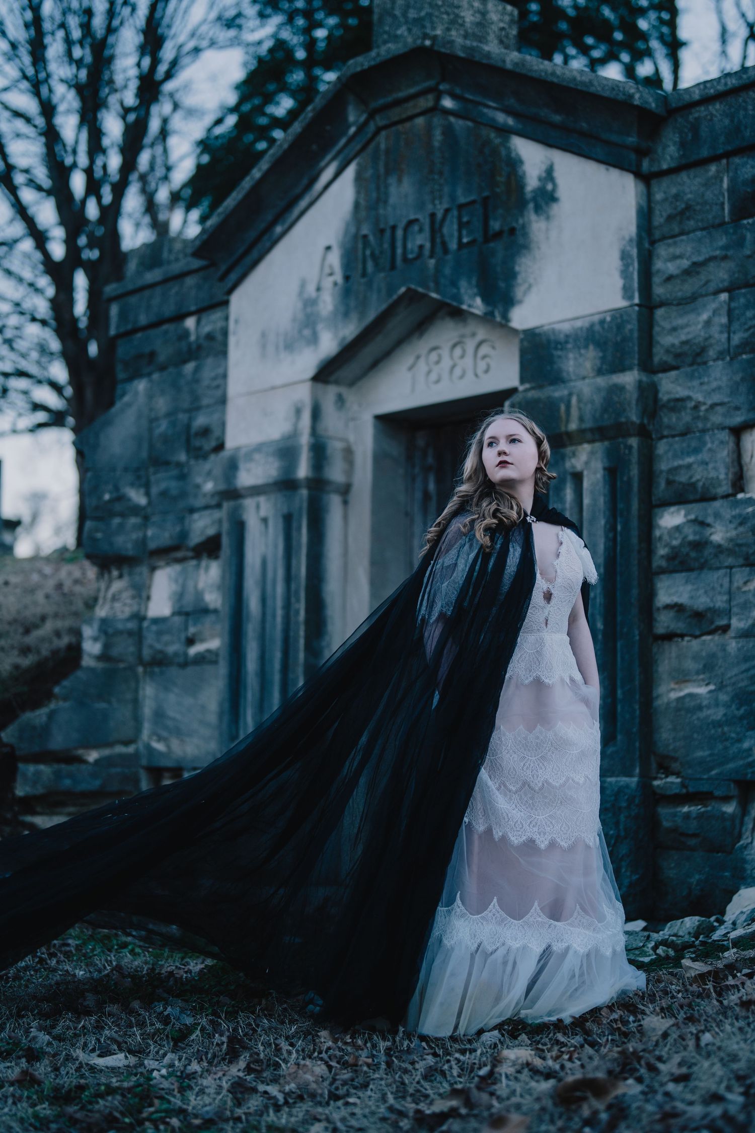 Gothic fashion photoshoot at an old stone mausoleum with dramatic moody lighting. Nashville, Tennessee.