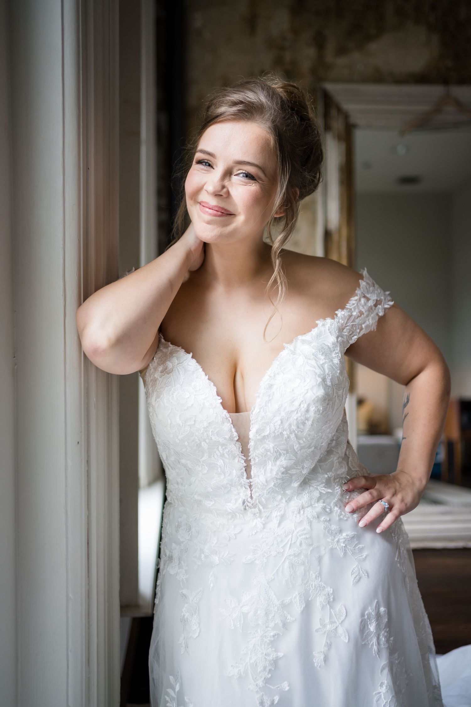 Beautiful wedding dress with lace details and plunging neckline. The Cordelle, Nashville, Tennessee.