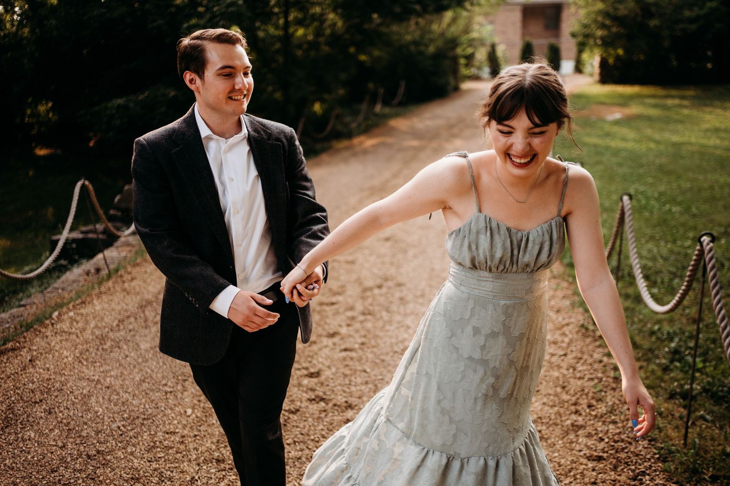 Joyful couple runs together on pathway while dressed in formal attire. Nashville, Tennessee.
