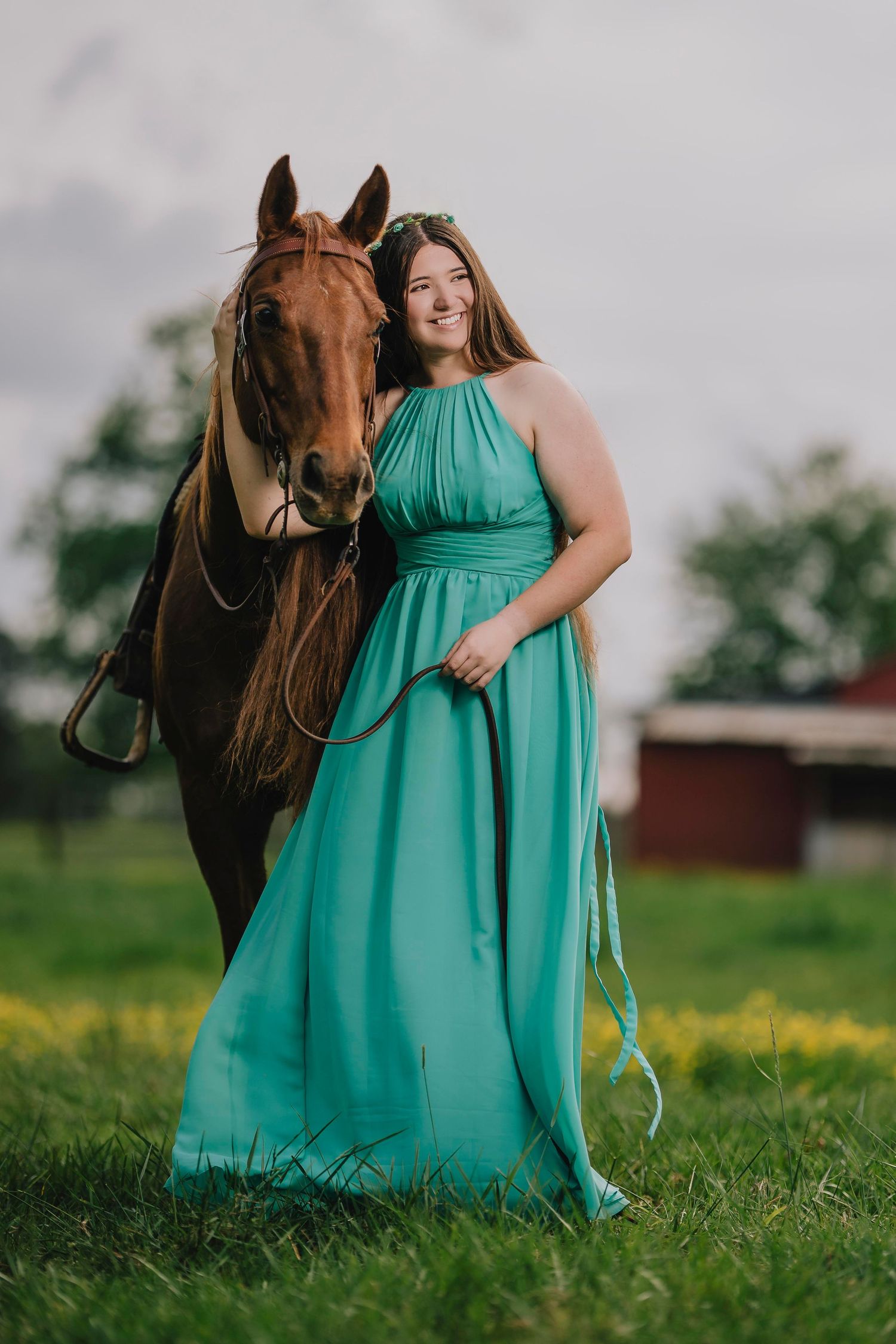 Woman in turquoise formal dress poses with brown horse in grassy field. Murfreesboro, Tennessee.