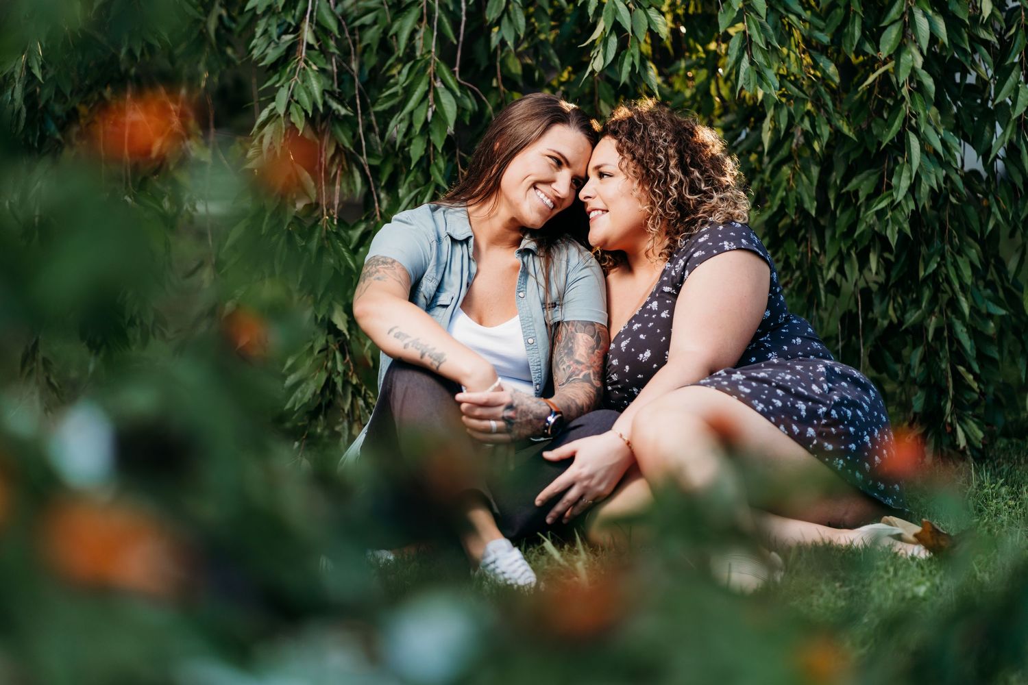 Candid romantic moment between two people sitting together under a willow tree. Nashville, Tennessee.