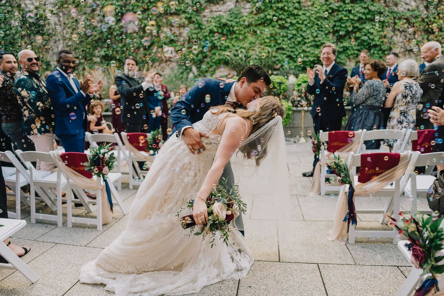A romantic dip during the first dance surrounded by wedding guests. Milwaukee, Wisconsin