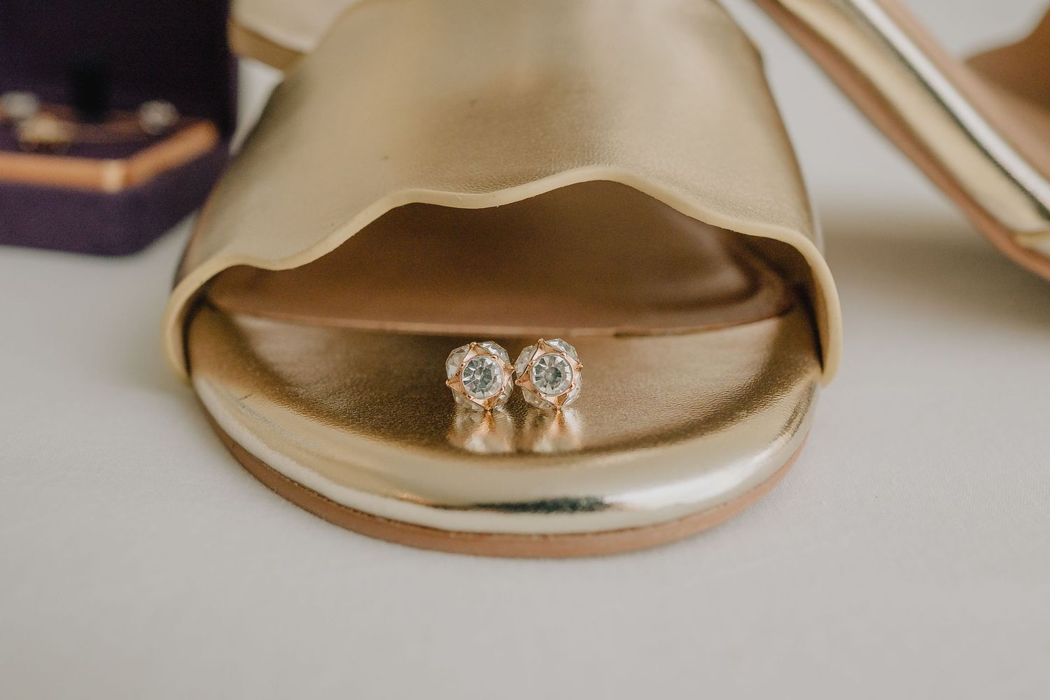 Sparkly diamond earrings nestled in a beige bridal shoe. Nashville, Tennessee.