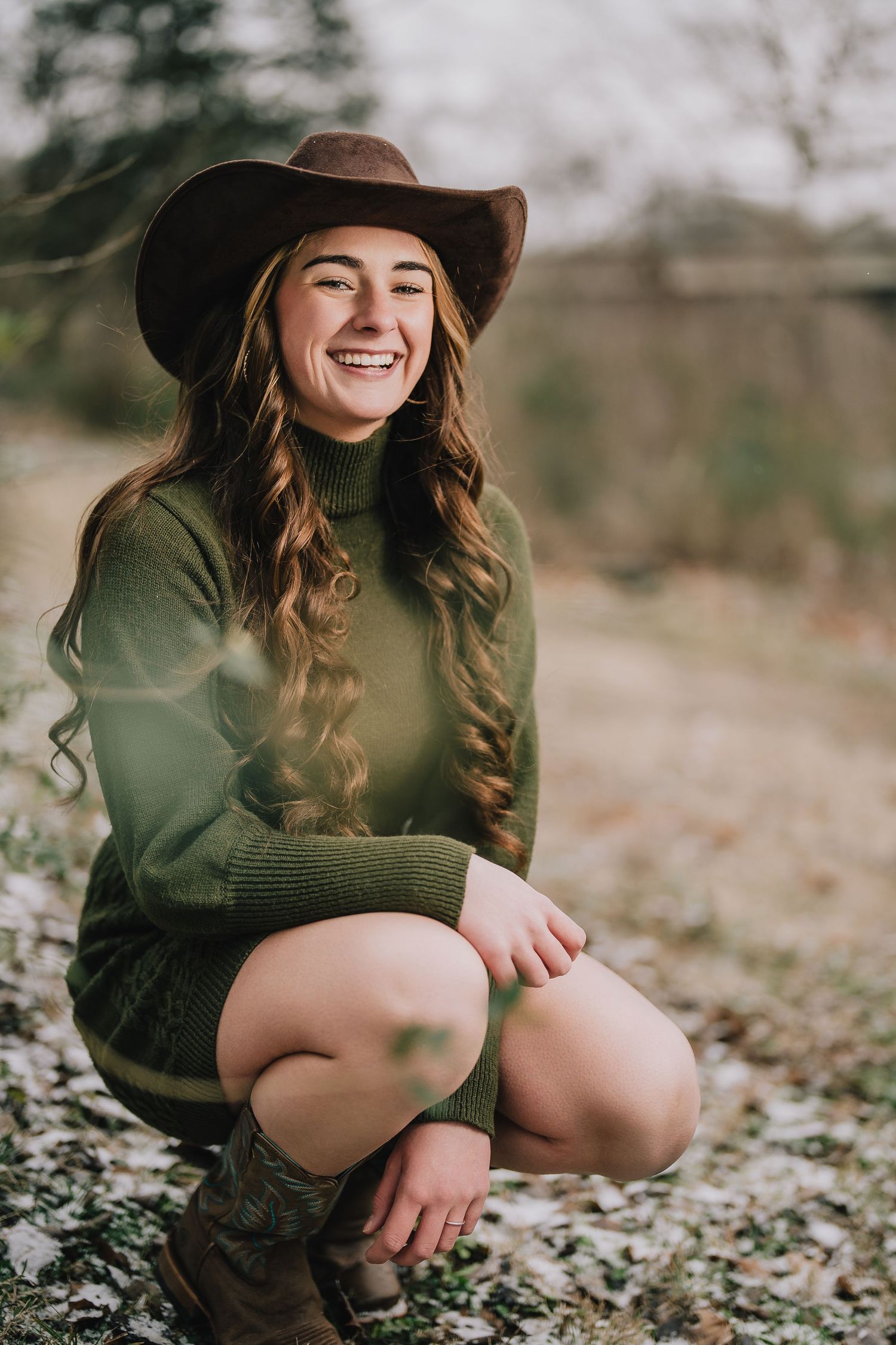 Autumn outdoor portrait in green sweater and brown hat among fallen leaves. Nashville, Tennessee.