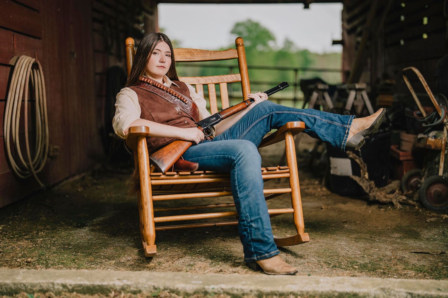 Person relaxes in wooden rocking chair on rustic porch. Murfreesboro, Tennessee.