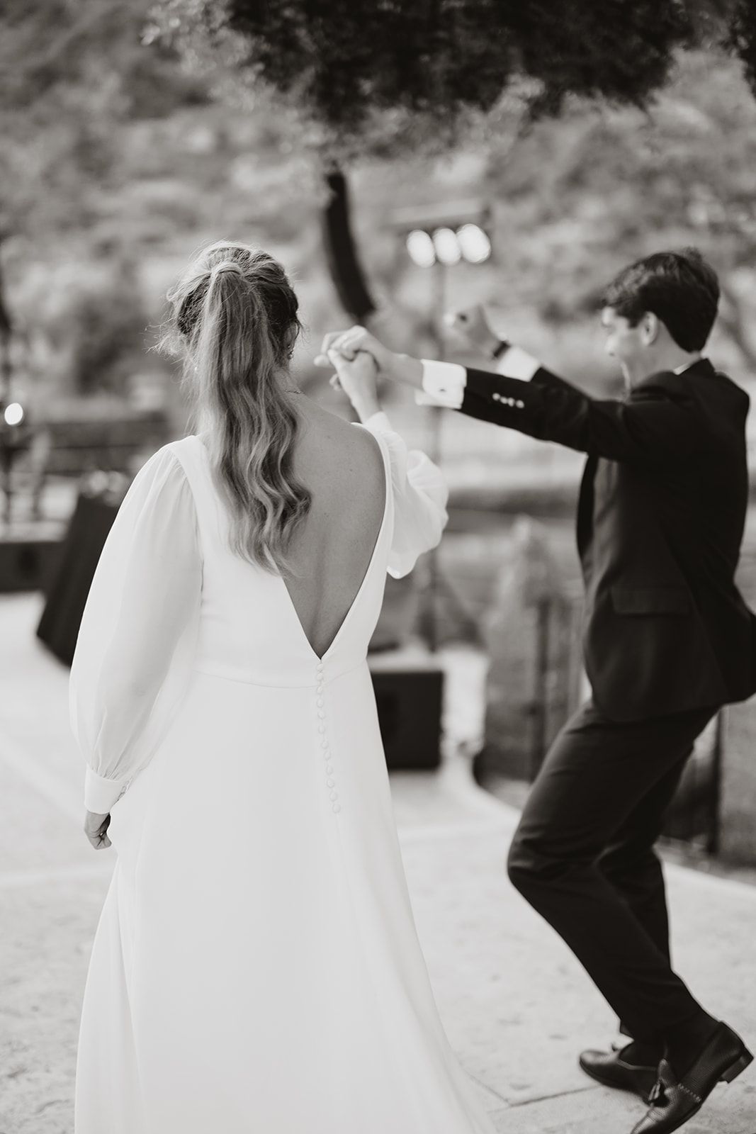 Black and white photo of a couple dancing at their wedding reception.