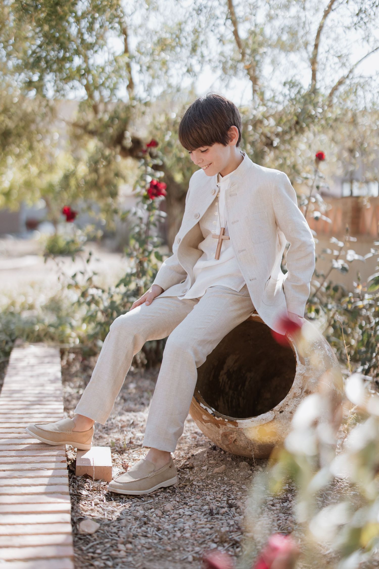 A series of artistic photos showing white shoes and pants against a natural outdoor backdrop with scattered red flowers.