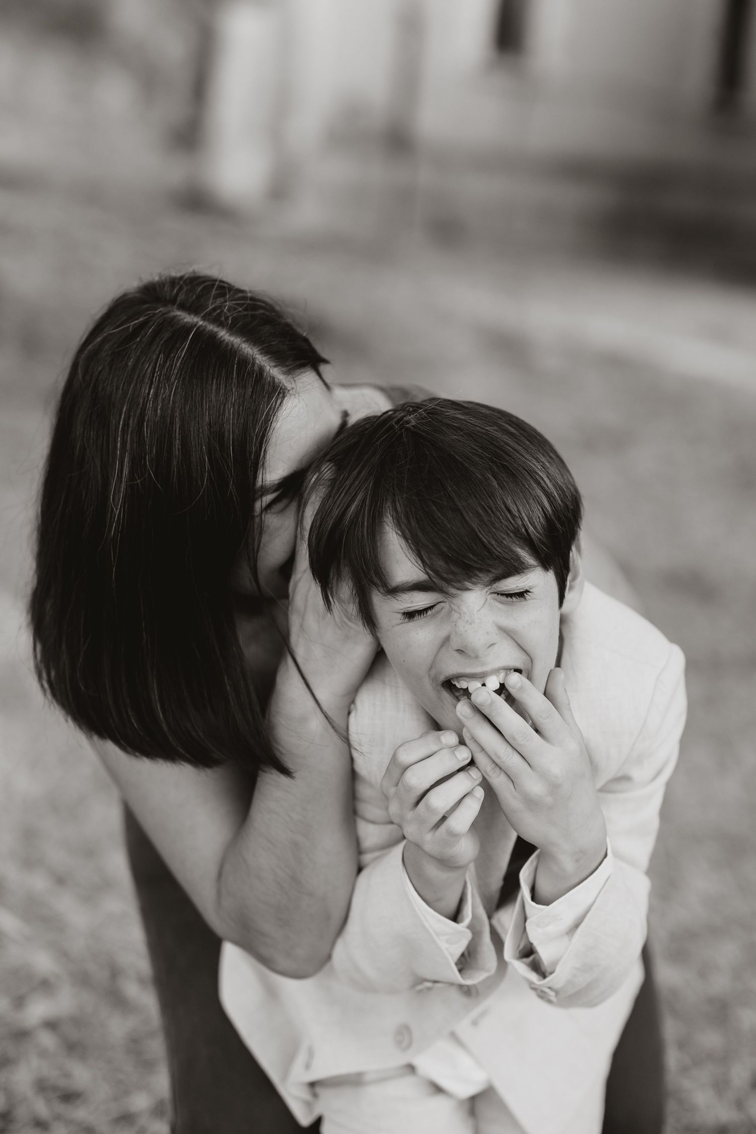 A series of intimate black and white photographs showing two people in white shirts sharing tender moments together.