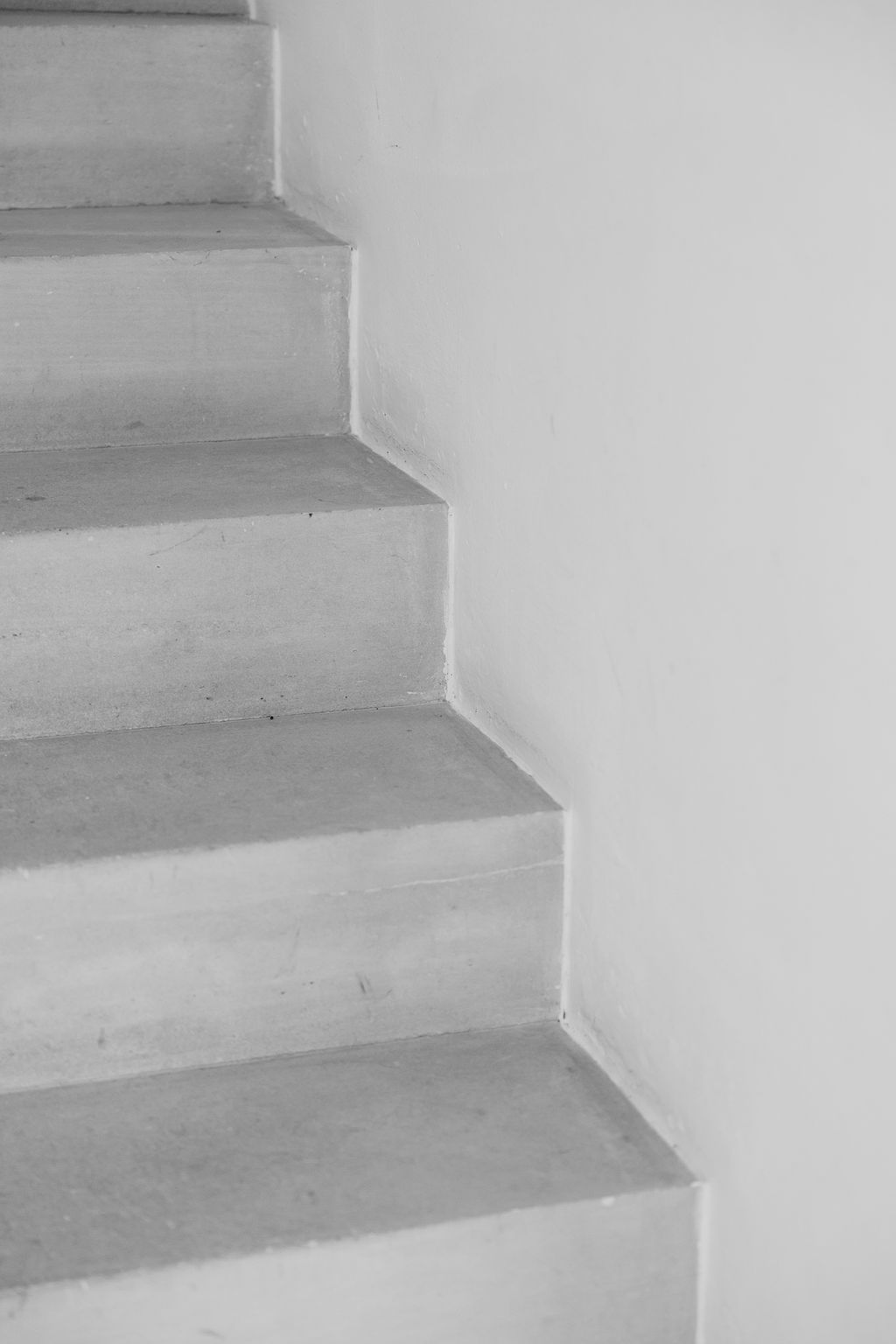 Minimalist architectural photo of white concrete staircase with clean lines.