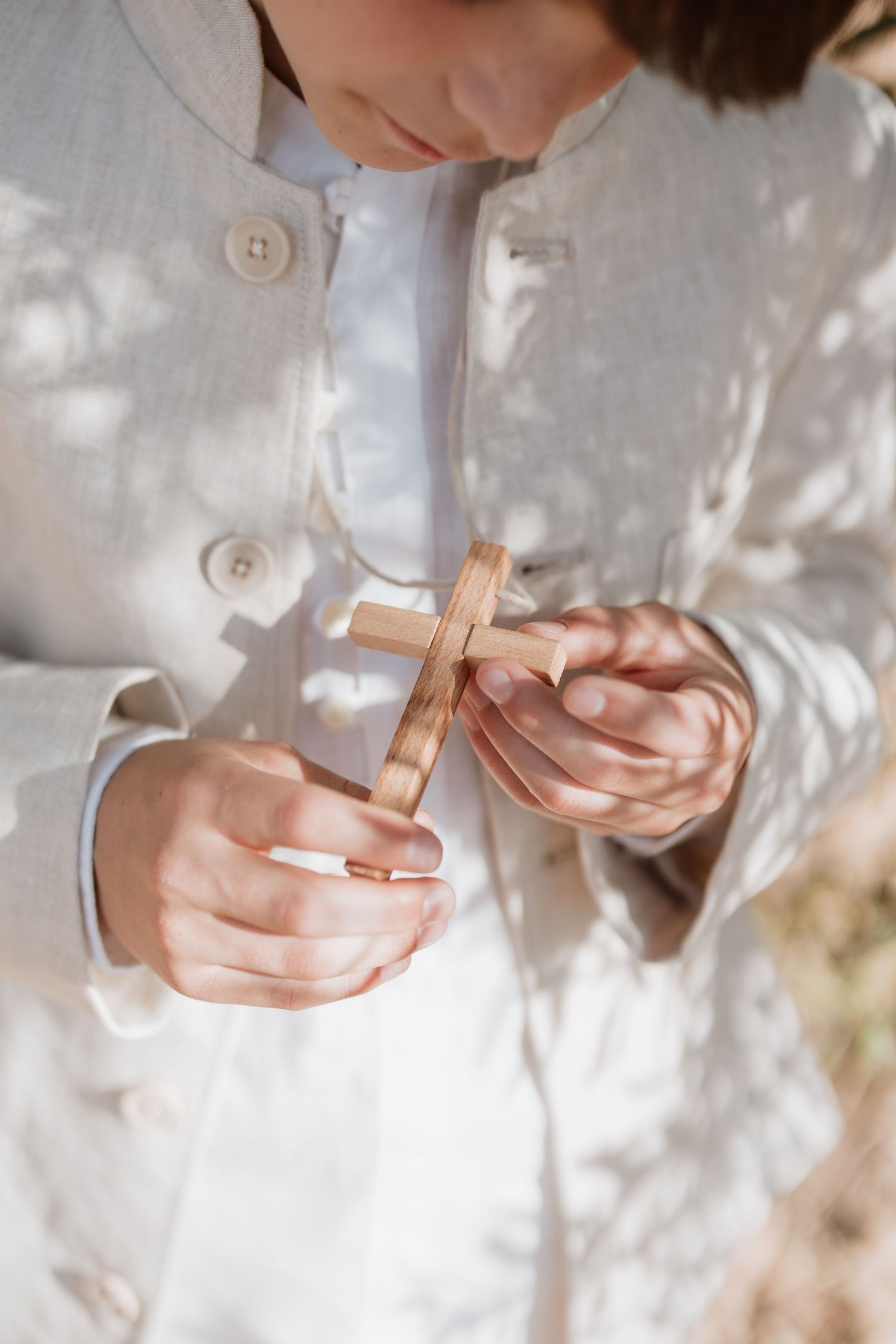 Close-up series of hands wrapping a small gift box in white paper creating a minimalist ethereal aesthetic.