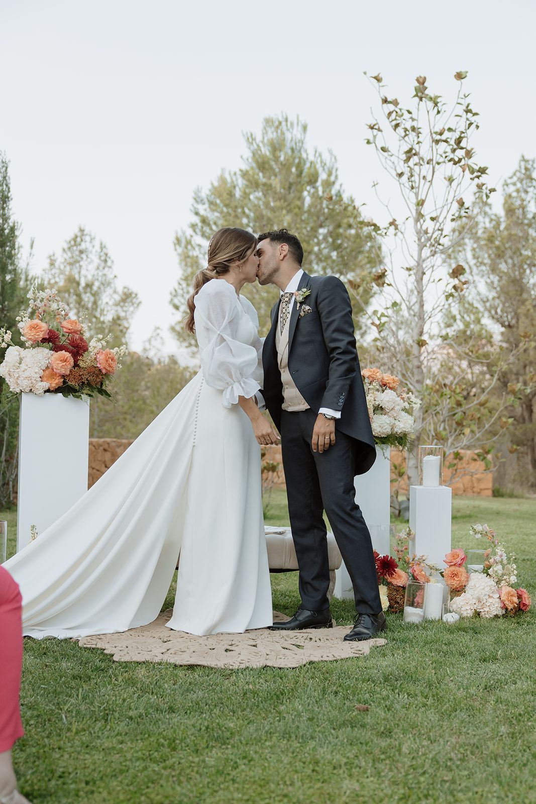 A romantic moment between newlyweds at their outdoor garden wedding ceremony.