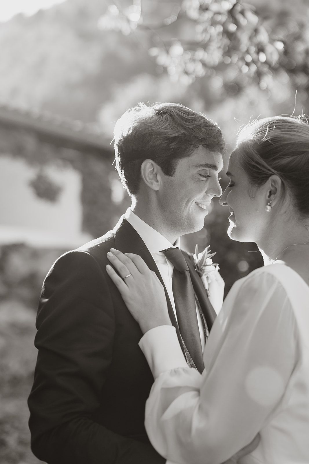 Intimate moment between couple during outdoor garden wedding.