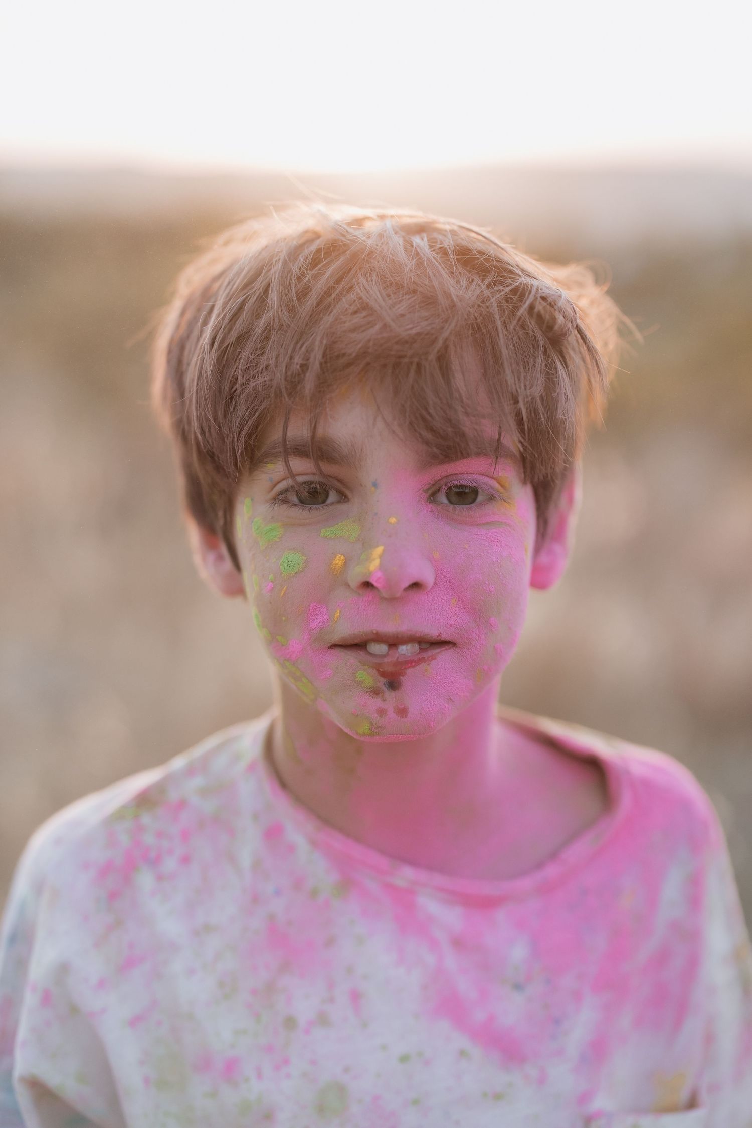 A progression of photos showing someone getting increasingly covered in bright pink powder during a color festival celebration.