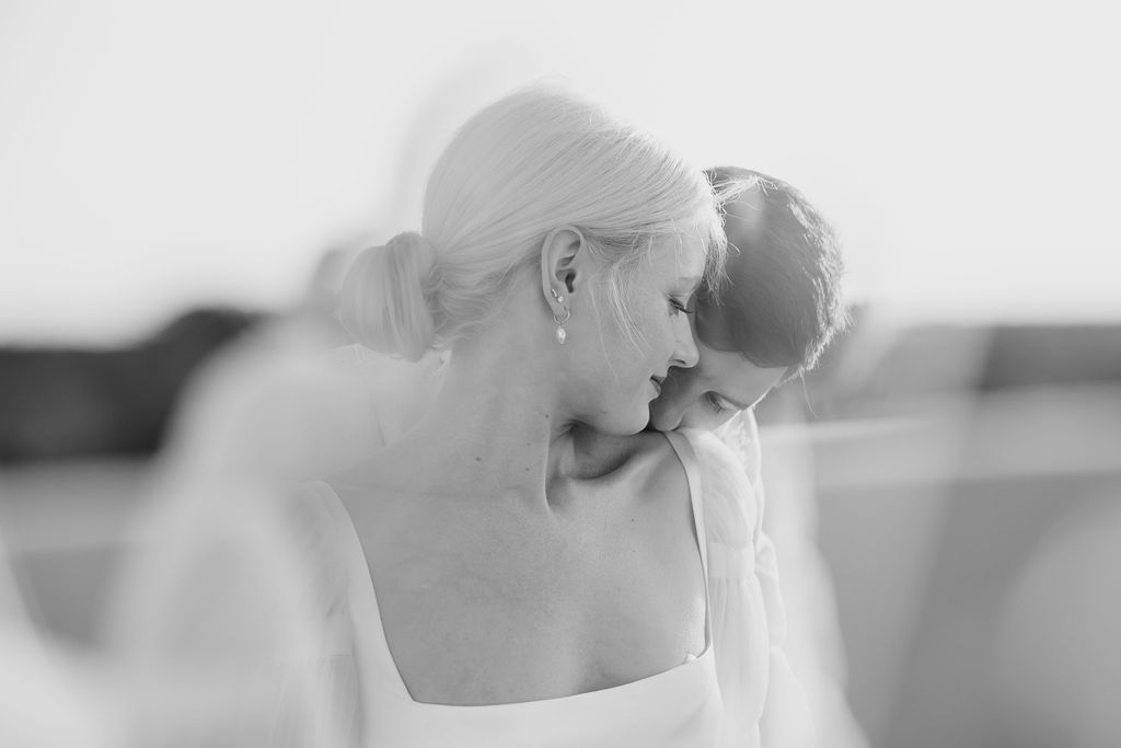 Romantic black and white wedding photograph with soft veil details.
