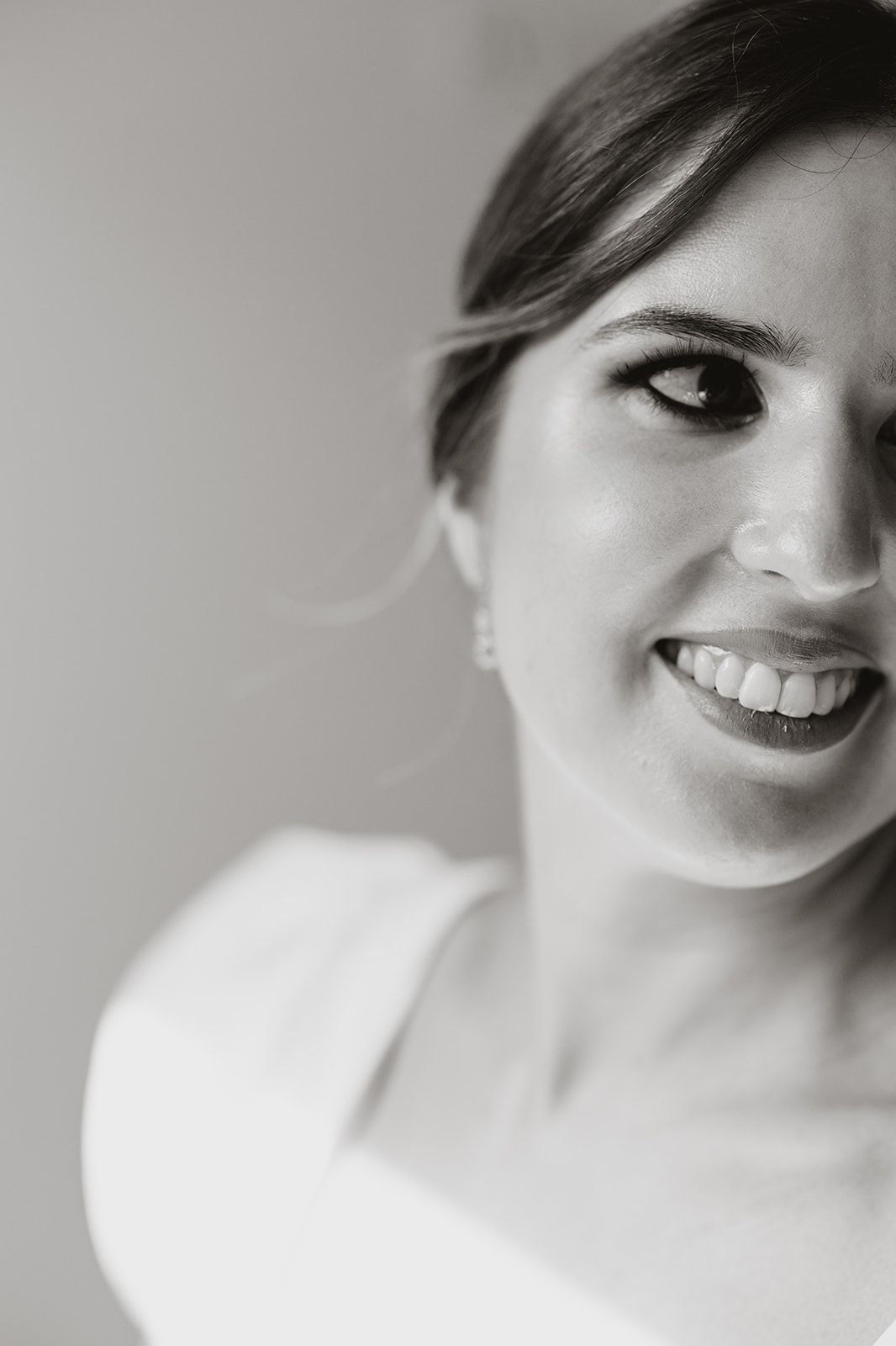 Black and white close-up portrait in bridal attire.
