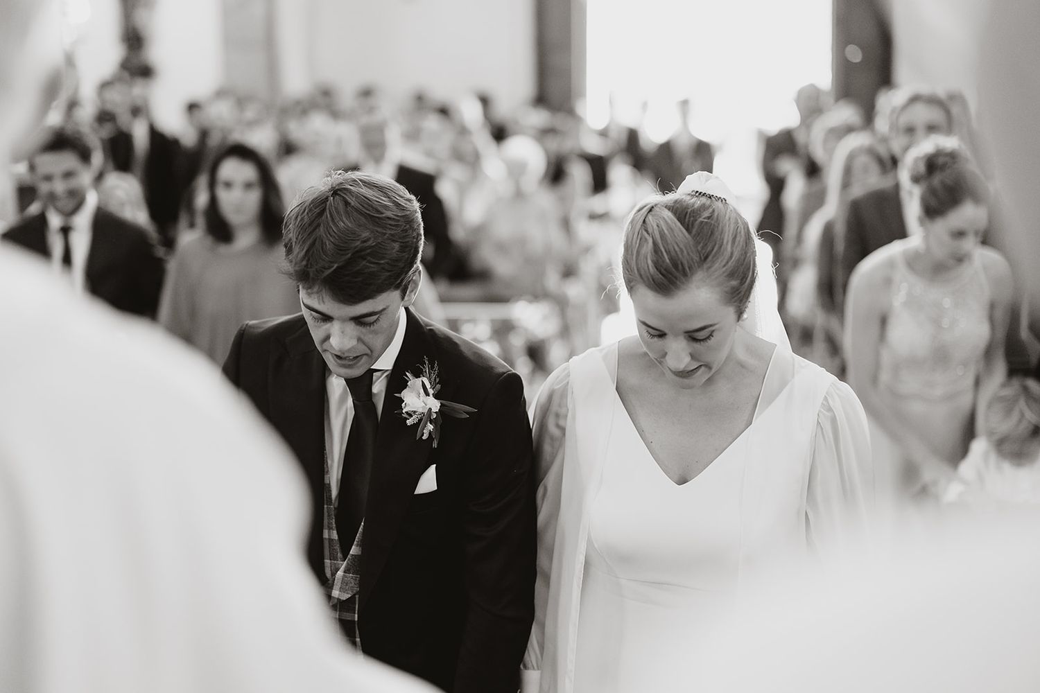 Black and white photograph of wedding ceremony inside historic church interior.