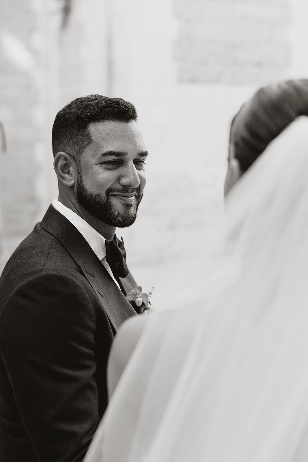 Black and white portrait from a wedding ceremony capturing a candid moment.