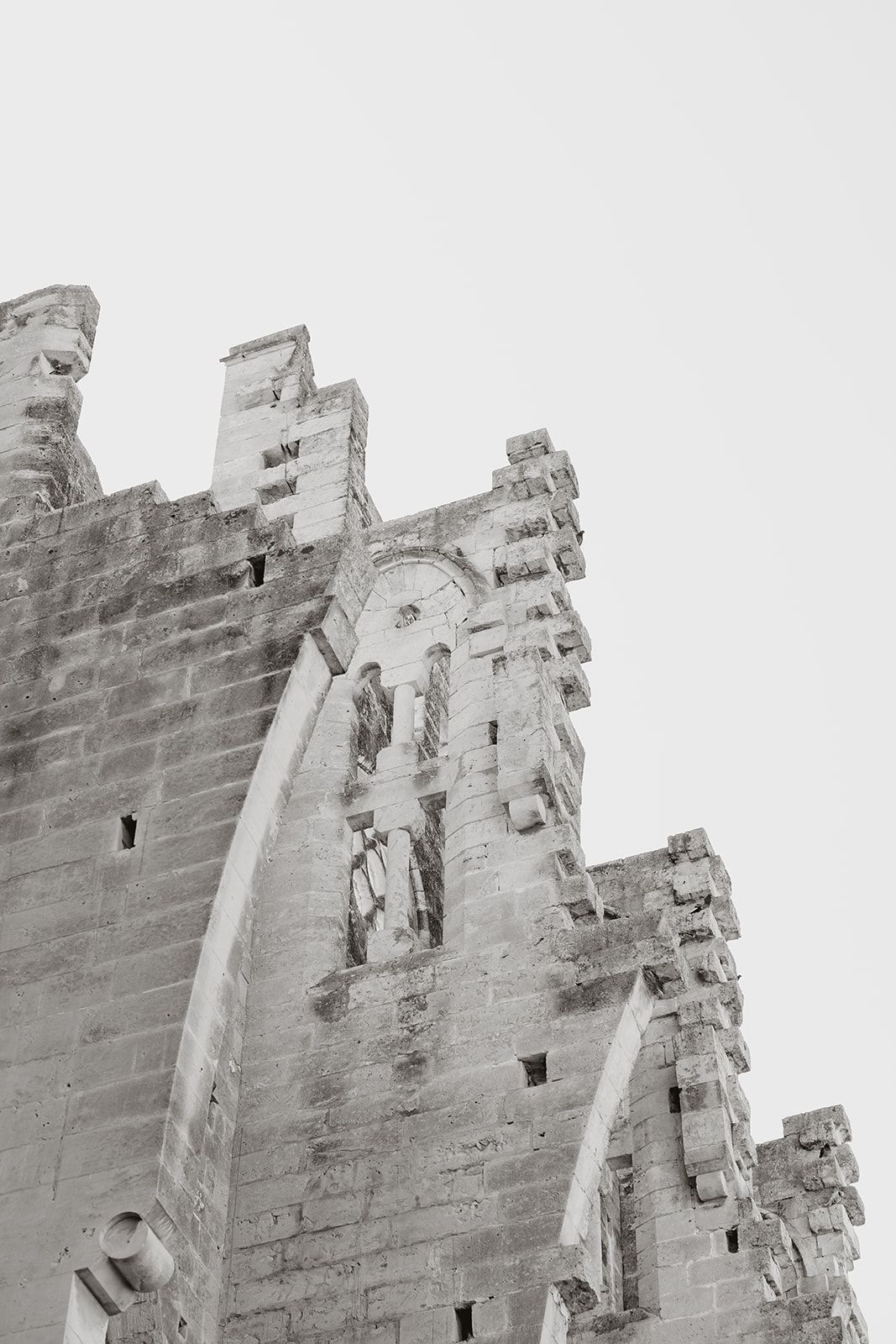 Black and white architectural detail of a Gothic stone church exterior with intricate carvings and spires.