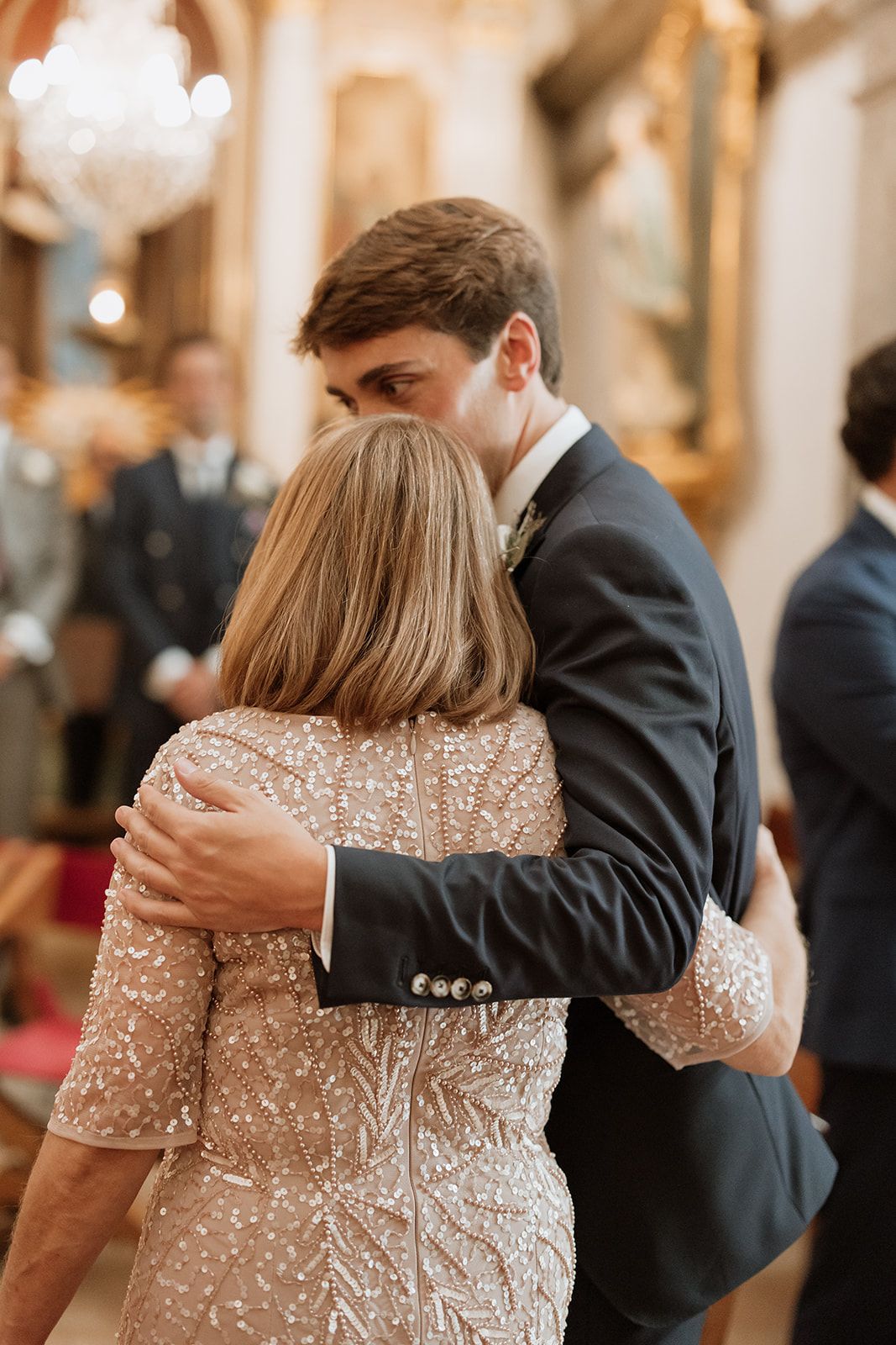 Intimate moment during wedding reception with sparkly dress details.