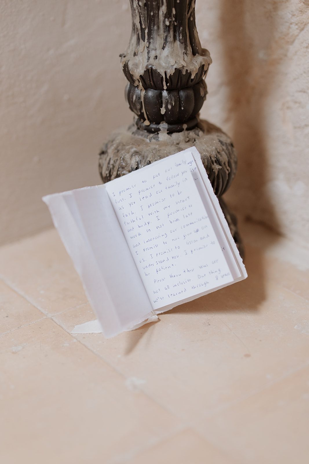 Handwritten note displayed on ornate vintage stand against neutral background.