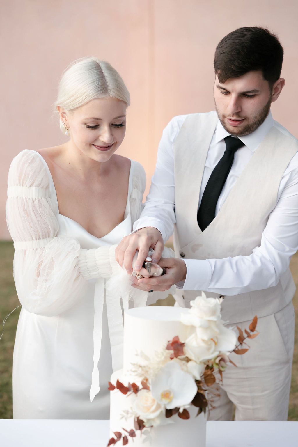 Couple sharing a moment while cutting their wedding cake together.