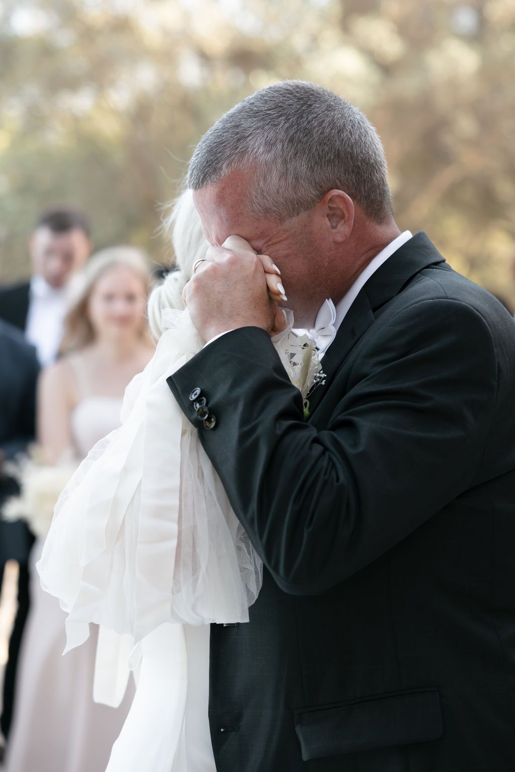 An emotional moment captured during a formal wedding dance.