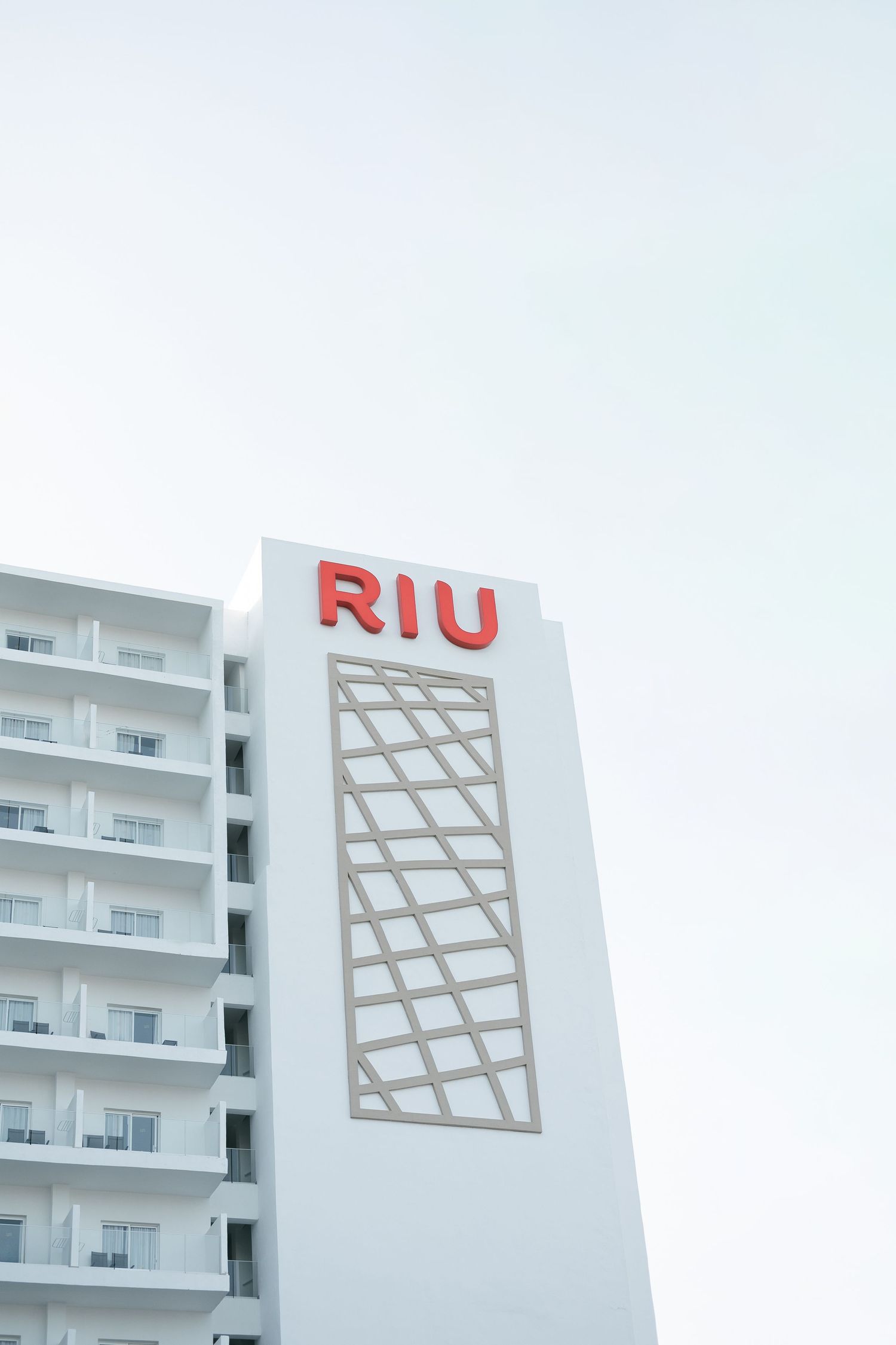 RIU hotel exterior featuring white modern architecture and distinctive branded signage.