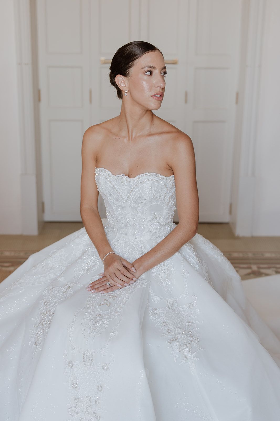 A stunning white ballgown wedding dress with intricate lace detailing shown in multiple angles.