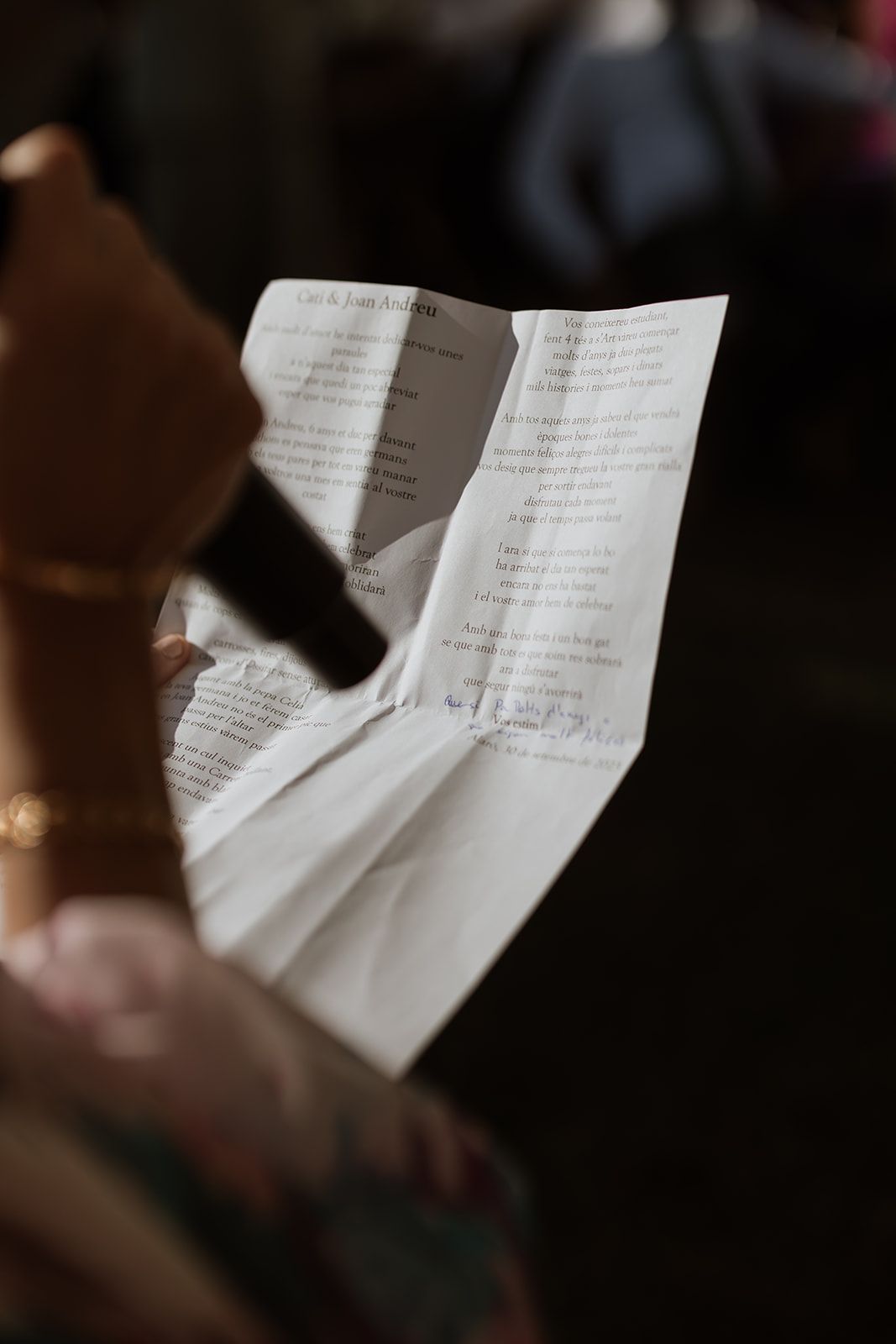 A close-up shot of wedding ceremony reading notes being held in hands.