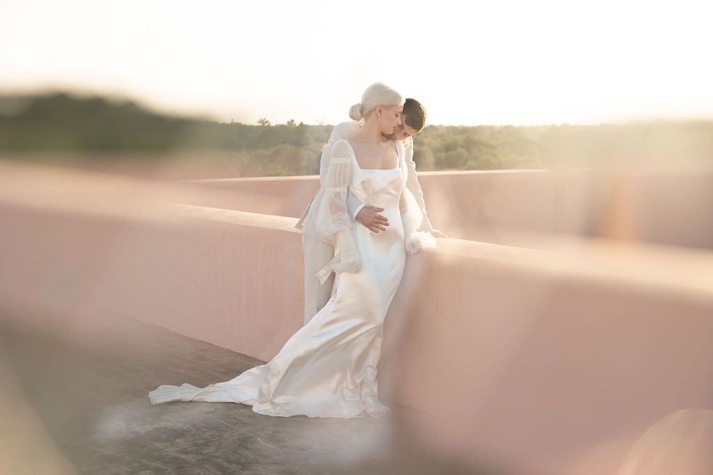 Romantic sunset bridal portrait with flowing gown and ethereal lighting effects.