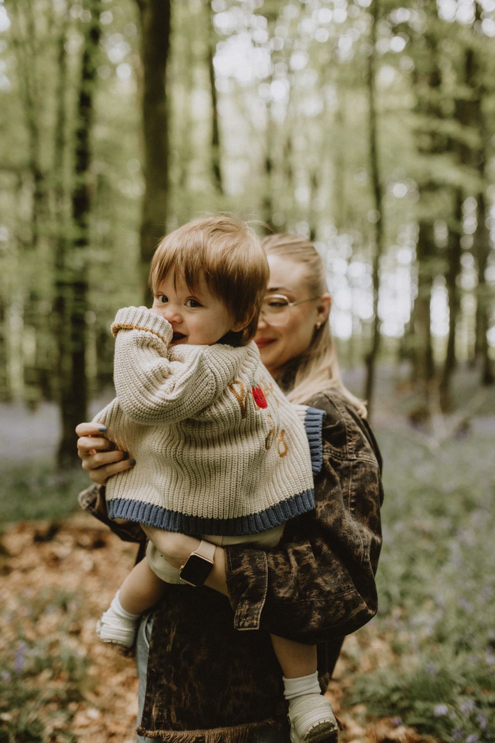 Sweet candid moments of togetherness in a spring woodland setting with bluebells blooming.